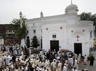 People gather outside All Saints Church in Peshawar, Pakistan, Sunday, after a suicide bombing attack killed scores of people earlier in the day, officials said. People gather outside All Saints Church in Peshawar, Pakistan, Sunday, after a suicide bombing attack killed scores of people earlier in the day, officials said.