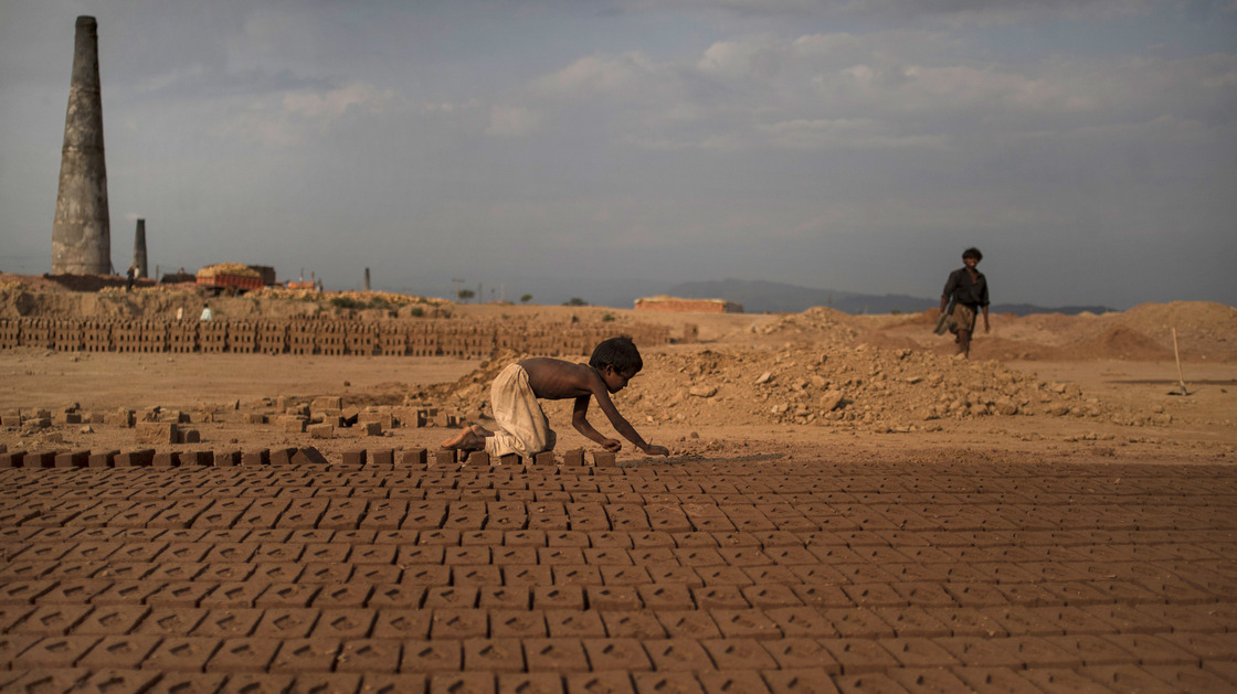 Near Islamabad, Pakistan, 6-year-old Jabro Mounir was arranging bricks this summer — part of his daily work at a brick-making facility. He earns a little less than $ 2 per day.