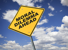 A yellow road sign reads: Moral Dilemma Ahead. A yellow road sign reads: Moral Dilemma Ahead.