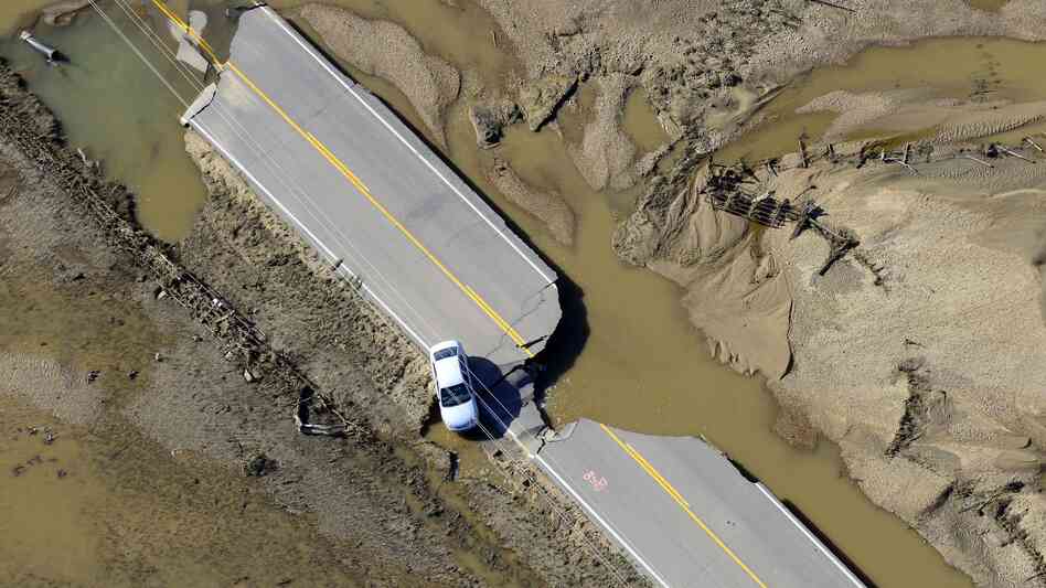 An abandoned car lies off a road devastated by floodwaters along the South Platte River east of Greeley, Colo., on Sept. 17. An abandoned car lies off a road devastated by floodwaters along the South Platte River east of Greeley, Colo., on Sept. 17.