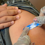 A student gets vaccinated against pertussis at a Los Angeles middle school in 2012. The state required that students be immunized to halt an epidemic of whooping cough.