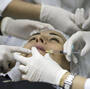 "Today society accepts the idea of improving one's image," says Dr. Ivo Pitanguy, Brazil's most famous plastic surgeon. Here a patient receives an injection of hyaluronic acid to plump up her lips at the Brazilian Society for Aesthetic Medicine in Rio de Janeiro in 2008.