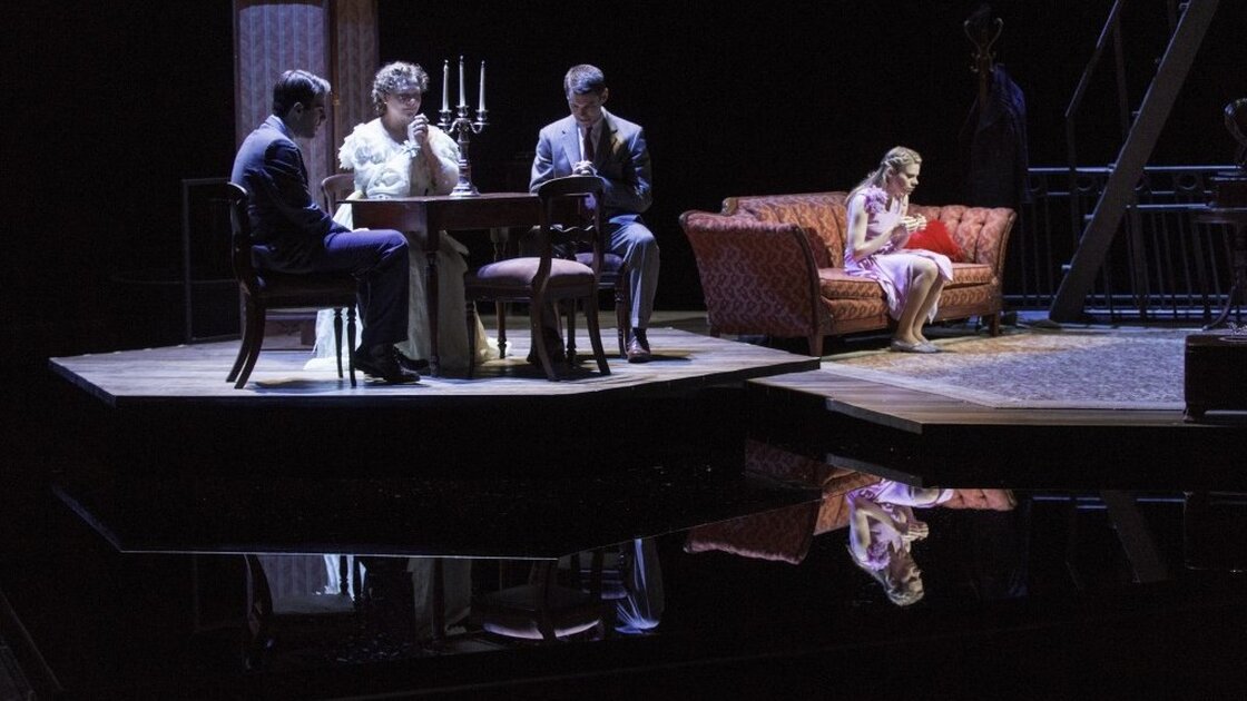 Zachary Quinto (left), Cherry Jones, Brian J. Smith and Celia Keenan-Bolger in The Glass Menagerie, which leaves out some of the elements — such as walls — you might expect in its St. Louis apartment set. The suggestive minimalism of the design is in keeping with the approach Tennessee Williams called for in his extensive stage directions. Zachary Quinto (left), Cherry Jones, Brian J. Smith and Celia Keenan-Bolger in The Glass Menagerie, which leaves out some of the elements — such as walls — you might expect in its St. Louis apartment set. The suggestive minimalism of the design is in keeping with the approach Tennessee Williams called for in his extensive stage directions.