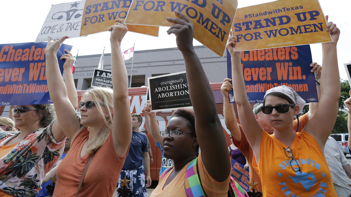 Women's health clinics have sued the state of Texas over its new abortion law, which they say will close more than a third of abortion providers in the state. Here, advocates for and against the bill are seen outside the Texas Capitol in Austin in July.