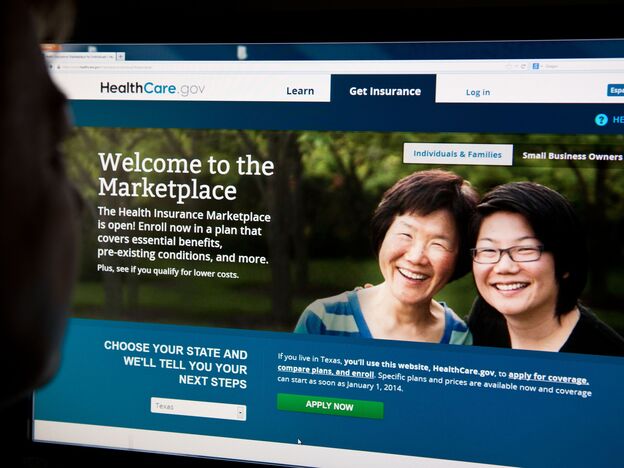 A woman looks at the HealthCare.gov insurance exchange site on Tuesday in Washington, D.C. (Image credit: AFP/Getty Images)