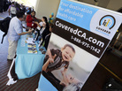 People get information on California's health exchange at a table at Union Station in Los Angeles on Tuesday, the exchange's opening day. People get information on California's health exchange at a table at Union Station in Los Angeles on Tuesday, the exchange's opening day.