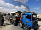 Palestinians inspect trucks loaded with iron arriving from Israel through the Kerem Shalom border crossing into Rafah, southern Gaza Strip, on Sept. 22. The delivery of the materials to the private sector is a first since the Hamas takeover in 2007. Palestinians inspect trucks loaded with iron arriving from Israel through the Kerem Shalom border crossing into Rafah, southern Gaza Strip, on Sept. 22. The delivery of the materials to the private sector is a first since the Hamas takeover in 2007.