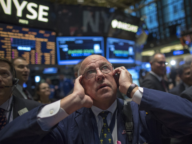 JPMorgan Chase trader Frederick Reimer works on the floor of the New York Stock Exchange. The government's monthly jobs numbers won't be released as scheduled Friday, leaving financial markets without key data to evaluate the economy. (Image credit: Reuters/Landov)