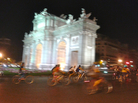 Cyclists whiz past Madrid's Puerta de Alcalá monument as part of Bici Crítica, a movement that seeks to raise awareness of bike safety. On the last Thursday of every month, thousands of cyclists ride in unison through downtown Madrid, blocking traffic during rush hour. Cyclists whiz past Madrid's Puerta de Alcalá monument as part of Bici Crítica, a movement that seeks to raise awareness of bike safety. On the last Thursday of every month, thousands of cyclists ride in unison through downtown Madrid, blocking traffic during rush hour.