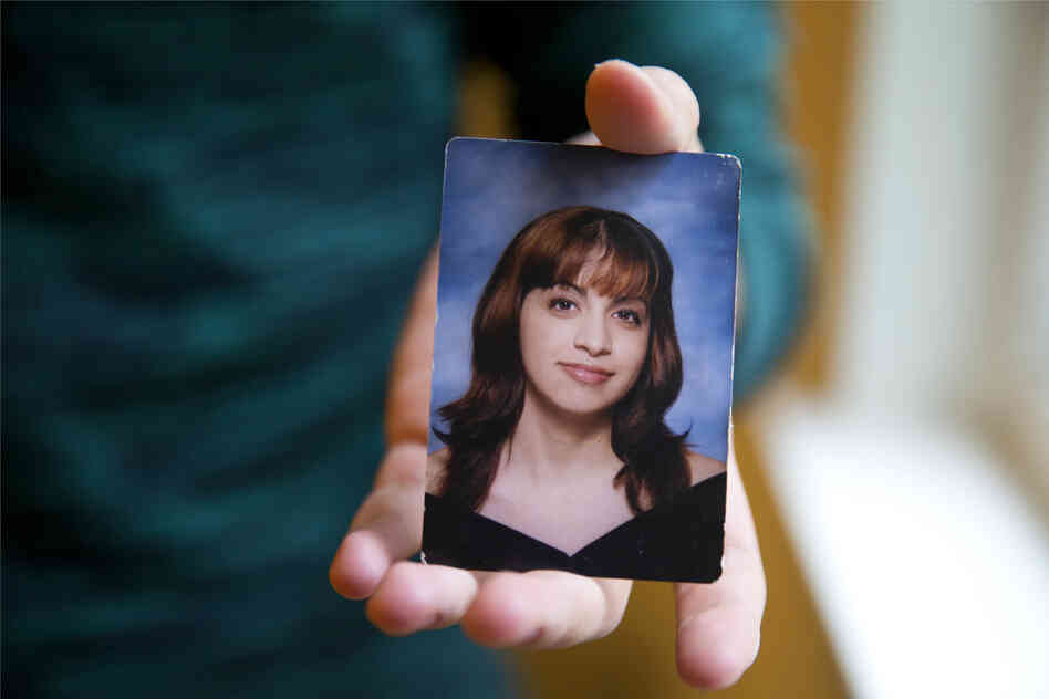 Younes holds a senior portrait picture of himself in high school when he was formerly Mariam. Being beautiful equated to becoming a good daughter in Younes' experiences with his family. 