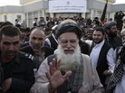 Abdul Rab Rasoul Sayyaf, an influential lawmaker and religious scholar, waves at his supporters on Oct. 3, after registering his candidacy in next year's presidential election. Abdul Rab Rasoul Sayyaf, an influential lawmaker and religious scholar, waves at his supporters on Oct. 3, after registering his candidacy in next year's presidential election.
