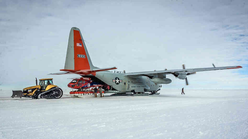 A helicopter is unloaded from an LC-130 in Antarctica last December. Researchers on this mission were studying the Pine Island Glacier, one of the fastest-receding glaciers on the continent. A helicopter is unloaded from an LC-130 in Antarctica last December. Researchers on this mission were studying the Pine Island Glacier, one of the fastest-receding glaciers on the continent.