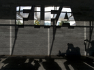 Shadows of journalists are seen next to a FIFA logo after a recent press conference on controversy swirling around 2022 World Cup construction projects in Qatar. Shadows of journalists are seen next to a FIFA logo after a recent press conference on controversy swirling around 2022 World Cup construction projects in Qatar.