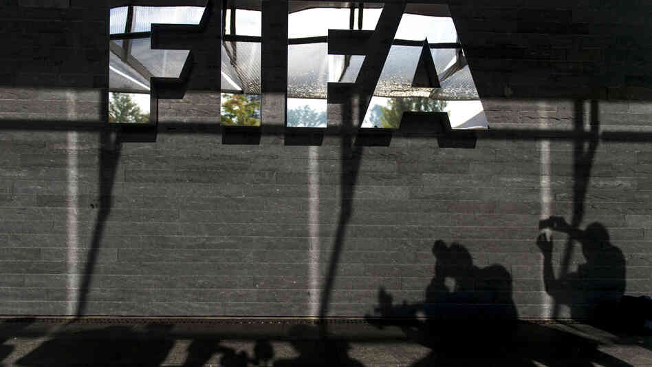 Shadows of journalists are seen next to a FIFA logo after a recent press conference on controversy swirling around 2022 World Cup construction projects in Qatar. Shadows of journalists are seen next to a FIFA logo after a recent press conference on controversy swirling around 2022 World Cup construction projects in Qatar.