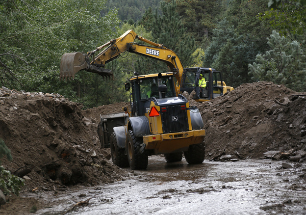 Heavy equipment works to clear a Jamestown road after a landslide covered it with more than 20 feet of mud. (Image credit: Reuters/Landov)