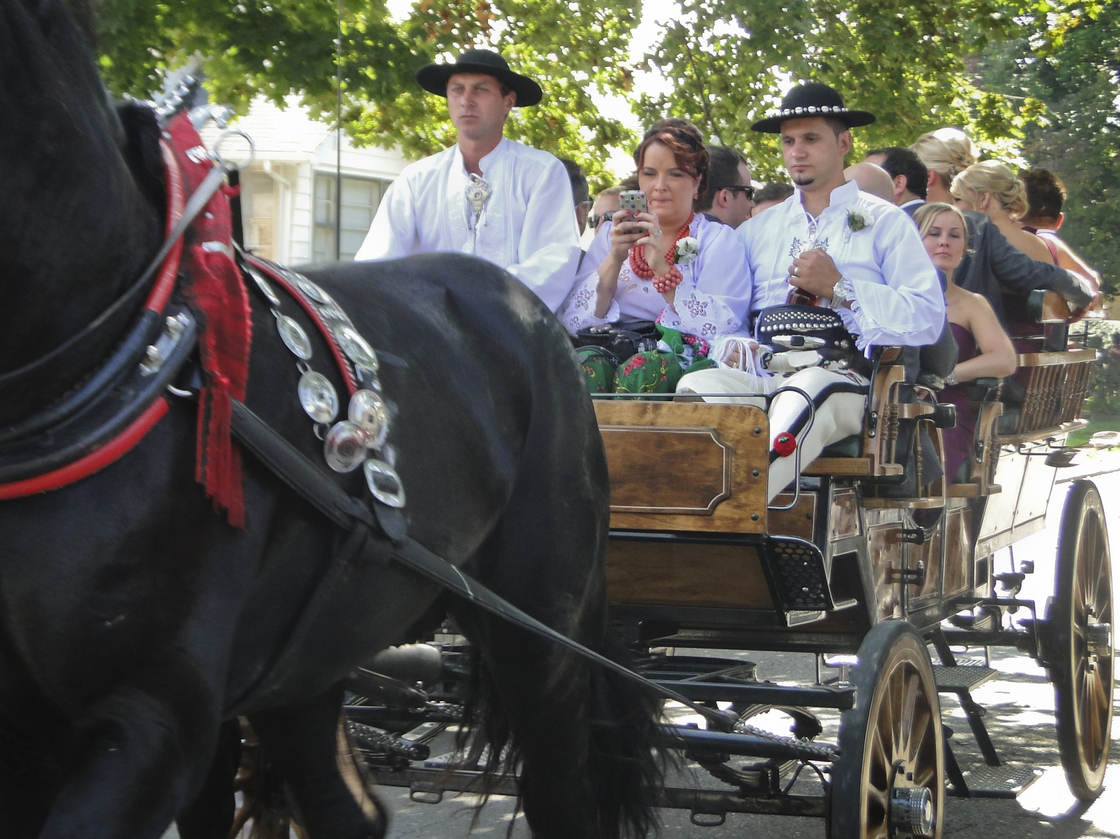Dressed in traditional Polish Highlander garb, guests pile into carriages that will bring them to the church for the official wedding ceremony.