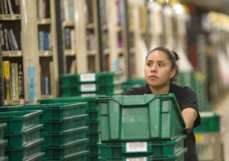 An Amazon.com employee gathers books for shipping at a warehouse in Fernley, Nev., in December 2008. An Amazon.com employee gathers books for shipping at a warehouse in Fernley, Nev., in December 2008.