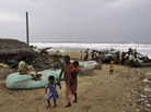 A woman leaves the Bay of Bengal coast with her children in the Ganjam district of Odisha, India. A woman leaves the Bay of Bengal coast with her children in the Ganjam district of Odisha, India.