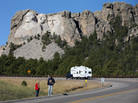 Tourists stop on the roadside near Mount Rushmore, after their visit was canceled due to the government shutdown. South Dakota and other states have reached an agreement to fund operations to reopen the parks. Tourists stop on the roadside near Mount Rushmore, after their visit was canceled due to the government shutdown. South Dakota and other states have reached an agreement to fund operations to reopen the parks.
