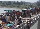 Indian villagers on tractors move past victims of a stampede on a bridge across the Sindh River in Madhya Pradesh state, India, on Sunday. Dozens of people died after a panic broke out. Indian villagers on tractors move past victims of a stampede on a bridge across the Sindh River in Madhya Pradesh state, India, on Sunday. Dozens of people died after a panic broke out.