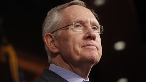 Senate Majority Leader Harry Reid of Nevada listens to a reporter's question about a meeting with Senate Republicans.