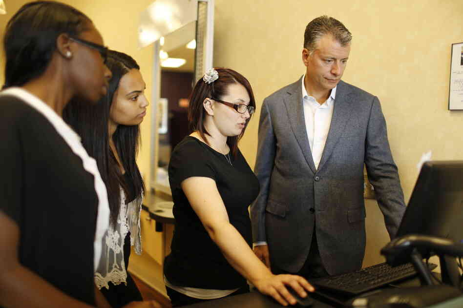 Though the Supercuts imprint is everywhere — from the wallpaper to the reception desk — Gary Robins (right) owns the business and is responsible for the bottom line. Robins and employees at his Havertown, Pa., location look over stats and sales for the week. Though the Supercuts imprint is everywhere — from the wallpaper to the reception desk — Gary Robins (right) owns the business and is responsible for the bottom line. Robins and employees at his Havertown, Pa., location look over stats and sales for the week.