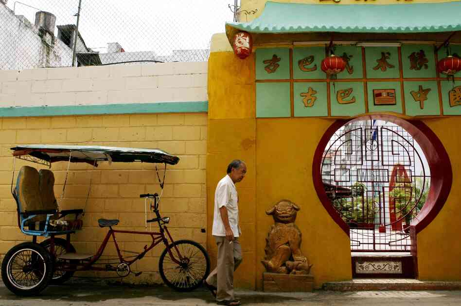 An unidentified Chinese man walks past a Cuban bicycle taxi and the main entrance of the Cuban Wushu Association of Havana's Chinatown on May 23, 2006. Fewer than 150 elderly Chinese immigrants remain in Havana. The Chinese presence in Cuba dates back to 1847, when a group of 200 immigrants from Canton province arrived on a Spanish ship to work on the island's sugarcane plantations. An unidentified Chinese man walks past a Cuban bicycle taxi and the main entrance of the Cuban Wushu Association of Havana's Chinatown on May 23, 2006. Fewer than 150 elderly Chinese immigrants remain in Havana. The Chinese presence in Cuba dates back to 1847, when a group of 200 immigrants from Canton province arrived on a Spanish ship to work on the island's sugarcane plantations.