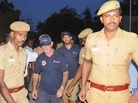 Indian policemen escort crew members of a U.S.-owned ship MV Seaman Guard Ohio outside a court in Tuticorin, in the southern Indian state of Tamil Nadu, on Friday. Indian policemen escort crew members of a U.S.-owned ship MV Seaman Guard Ohio outside a court in Tuticorin, in the southern Indian state of Tamil Nadu, on Friday.