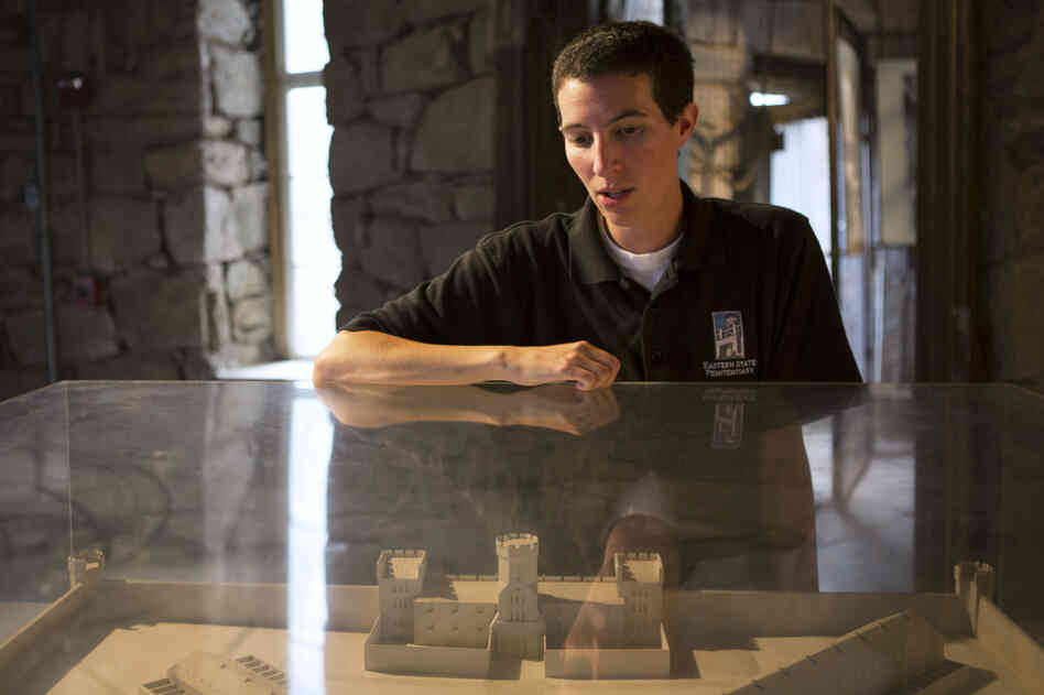Ben Bookman, a tour guide at Eastern State Penitentiary, uses a diorama to point out the prison's cellblocks. Ben Bookman, a tour guide at Eastern State Penitentiary, uses a diorama to point out the prison's cellblocks.