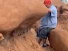 A man topples a rock formation from the Jurassic Period. A man topples a rock formation from the Jurassic Period.