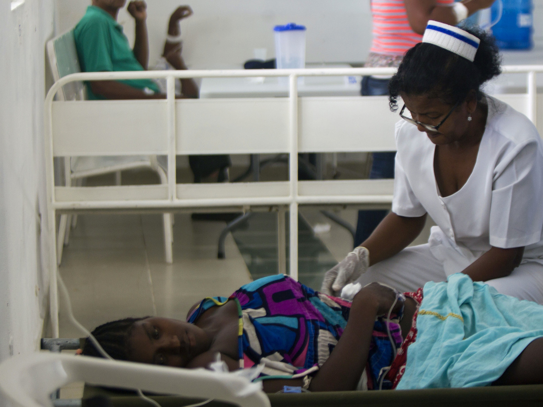 A nurse treats a cholera patient in the Dominican Republic on Aug. 27, at the Juan Pablo Pina Hospital in San Cristobal. Health officials say that the strain of cholera circulating in the Dominican Republic — the same one that first appeared in Haiti three years ago — has also caused outbreaks in Cuba and now Mexico.