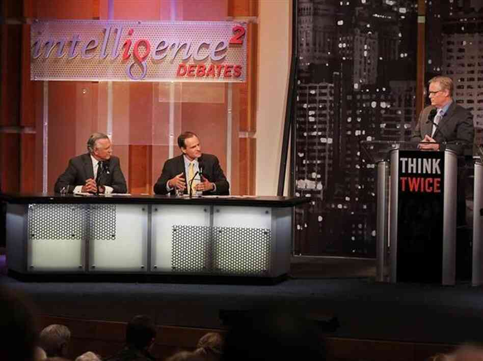 Richard Fisher (left) and Simon Johnson argue in favor of breaking up big banks in an Intelligence Squared U.S. debate, as moderator John Donvan looks on. Richard Fisher (left) and Simon Johnson argue in favor of breaking up big banks in an Intelligence Squared U.S. debate, as moderator John Donvan looks on.