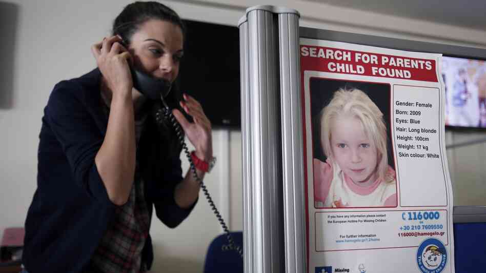 A woman takes a call at the Greek charity The Smile of the Child, which is caring for a girl who police say was abducted by a Roma couple. Officials are trying to find her biological parents. A woman takes a call at the Greek charity The Smile of the Child, which is caring for a girl who police say was abducted by a Roma couple. Officials are trying to find her biological parents.