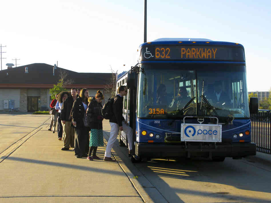 Commuters board shuttle buses at the Lake-Cook Metra rail stop in Chicago's northern suburbs. This Shuttle Bug program is a collaboration between area employers and the suburban transit agency, PACE, to provide better transit options for workers, especially those who live in the city but work in the Lake-Cook job corridor. Commuters board shuttle buses at the Lake-Cook Metra rail stop in Chicago's northern suburbs. This Shuttle Bug program is a collaboration between area employers and the suburban transit agency, PACE, to provide better transit options for workers, especially those who live in the city but work in the Lake-Cook job corridor.