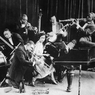 King Oliver's Creole Jazz Band in Chicago in 1923: Louis Armstrong is kneeling, from left to right behind him are Honore Dutrey, Baby Dodds, King Oliver, Lil Hardin, Bill Johnson and Johnny Dodds. King Oliver's Creole Jazz Band in Chicago in 1923: Louis Armstrong is kneeling, from left to right behind him are Honore Dutrey, Baby Dodds, King Oliver, Lil Hardin, Bill Johnson and Johnny Dodds.