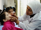 A health worker administers polio vaccine as part of a UNICEF-supported campaign in Damascus. Aid agencies sometimes have to negotiate with rebel groups and work in dangerous situations to immunize vulnerable children. A health worker administers polio vaccine as part of a UNICEF-supported campaign in Damascus. Aid agencies sometimes have to negotiate with rebel groups and work in dangerous situations to immunize vulnerable children.