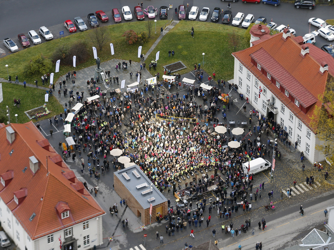 People gather in the central square of Rjukan, Norway, on Wednesday to bask in the sun reflected by mirrors on a nearby mountainside.