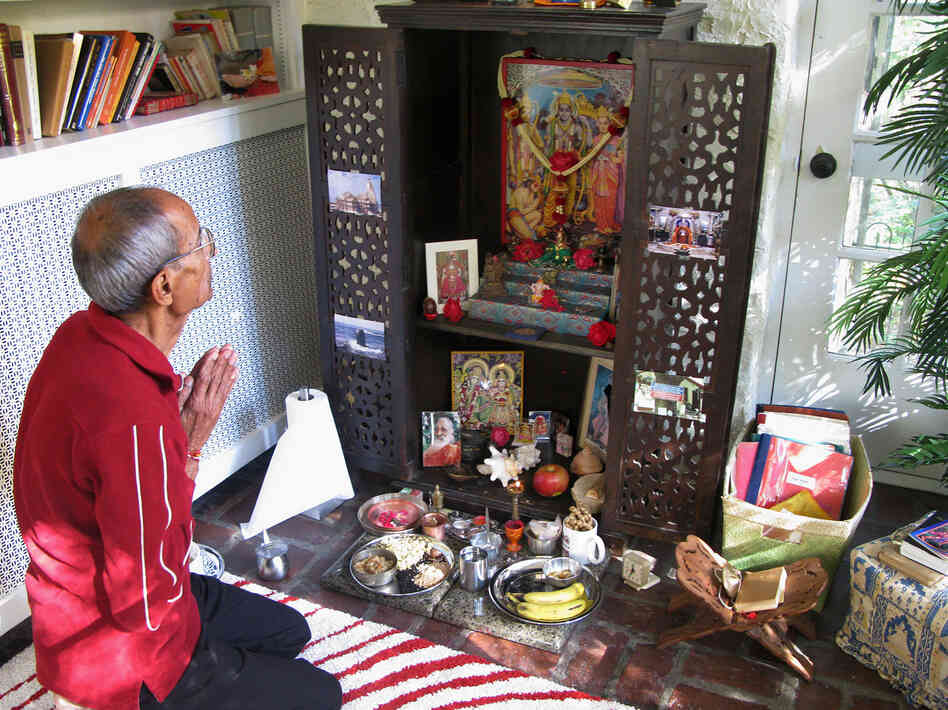 Ravindra Shukla, Aseem's father, kneels before the family altar as part of the holiday celebration. Ravindra Shukla, Aseem's father, kneels before the family altar as part of the holiday celebration.