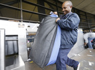 Skycap Biniyam Yehuala hefts a traveler's bag at Seattle-Tacoma International Airport. On Tuesday, voters in SeaTac, Wash., approved a minimum wage of $15 an hour for roughly 6,300 low wage workers' whose jobs are at or near the airport. Skycap Biniyam Yehuala hefts a traveler's bag at Seattle-Tacoma International Airport. On Tuesday, voters in SeaTac, Wash., approved a minimum wage of $15 an hour for roughly 6,300 low wage workers' whose jobs are at or near the airport.