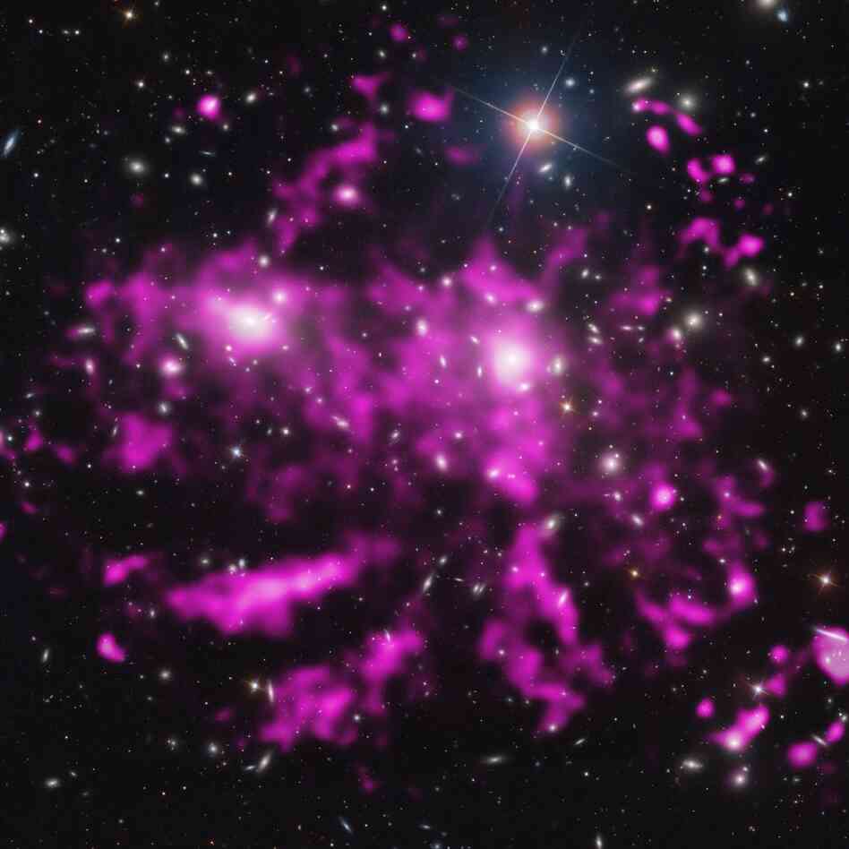 The hunt for dark matter started with astronomer Fritz Zwicky's observations of the Coma galaxy cluster in the 1930s. This recent image of the Coma cluster combines optical and X-ray observations from the Chandra mission. The hunt for dark matter started with astronomer Fritz Zwicky's observations of the Coma galaxy cluster in the 1930s. This recent image of the Coma cluster combines optical and X-ray observations from the Chandra mission.
