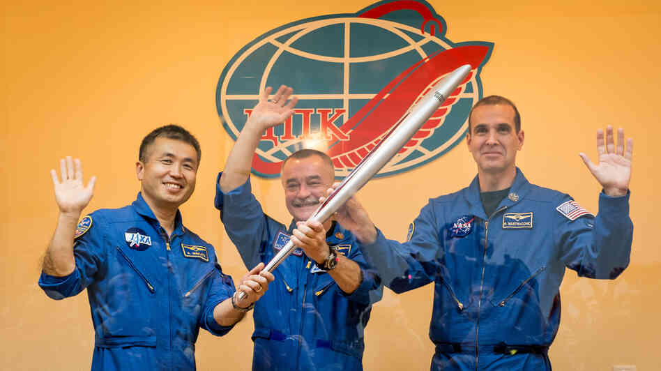Flight Engineer Koichi Wakata of the Japan Aerospace Exploration Agency, left, Soyuz Commander Mikhail Tyurin of the Russian space agency Roscosmos, and Flight Engineer Rick Mastracchio of NASA, hold the Olympic torch that will be flown with them to the International Space Station, during a press conference on Wednesday. Flight Engineer Koichi Wakata of the Japan Aerospace Exploration Agency, left, Soyuz Commander Mikhail Tyurin of the Russian space agency Roscosmos, and Flight Engineer Rick Mastracchio of NASA, hold the Olympic torch that will be flown with them to the International Space Station, during a press conference on Wednesday.