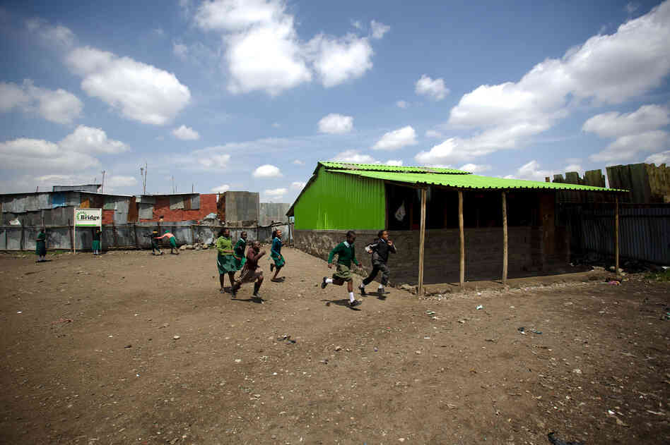 Students run across the yard of the for-profit Bridge International Academy in the Nairobi slum of Mukuru kwa Njenga. Students run across the yard of the for-profit Bridge International Academy in the Nairobi slum of Mukuru kwa Njenga.