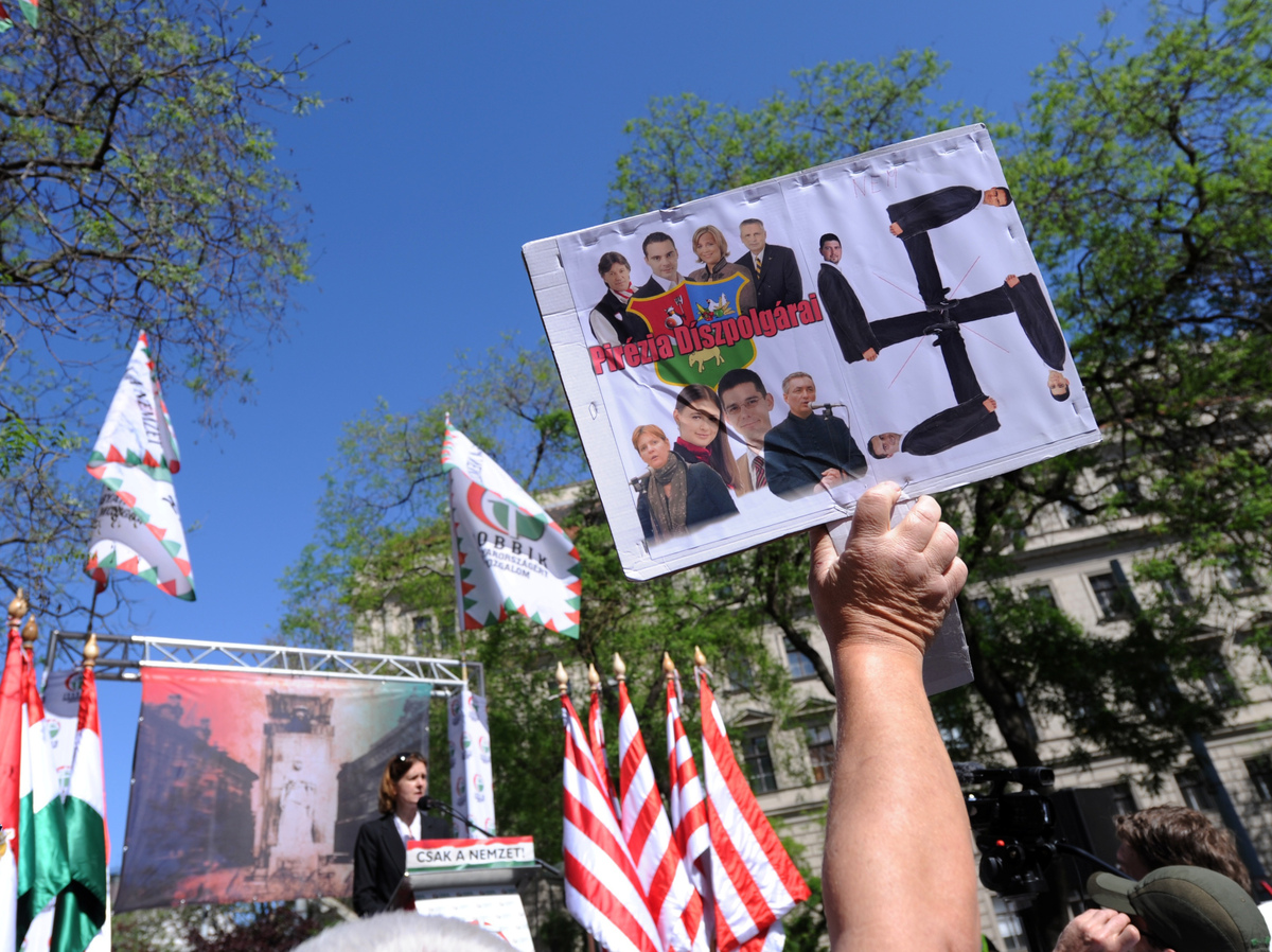A counterprotester lifts a homemade sign during a demonstration of the nationalist party in downtown Budapest, Hungary, on May 4.