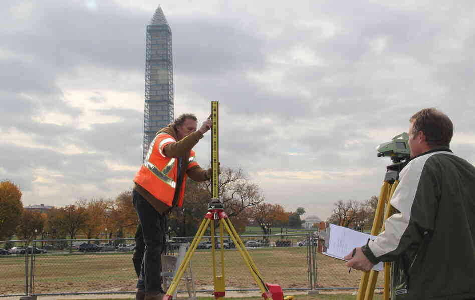 National Geodetic Survey crew members Roy Anderson, left, and Steve Breidenbach set up survey equipment used to measure the height of the Washington Monument. National Geodetic Survey crew members Roy Anderson, left, and Steve Breidenbach set up survey equipment used to measure the height of the Washington Monument.