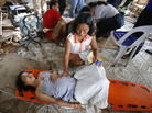 A woman comforts a pregnant relative suffering labor pains at a makeshift birthing clinic in the typhoon-battered city of Tacloban, Philippines, on Monday. A woman comforts a pregnant relative suffering labor pains at a makeshift birthing clinic in the typhoon-battered city of Tacloban, Philippines, on Monday.