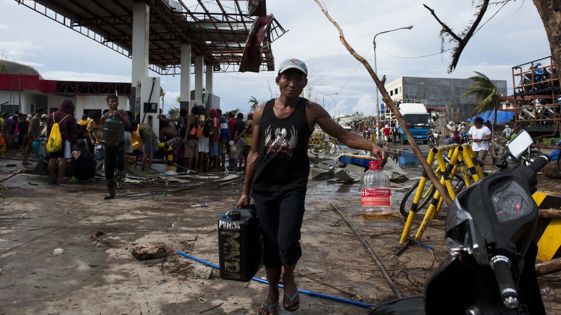Residents collect gasoline at a damaged gas station in Tacloban, the Philippines, on Wednesday. Residents collect gasoline at a damaged gas station in Tacloban, the Philippines, on Wednesday.