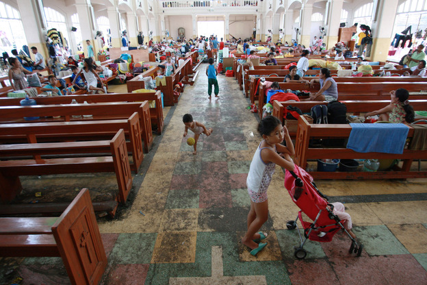 Residents take shelter at a church in Tacloban. On Wednesday, the Philippines' National Disaster Risk Reduction And Management Council estimated 600,000 people have been displaced because of the typhoon. (Image credit: Getty Images)