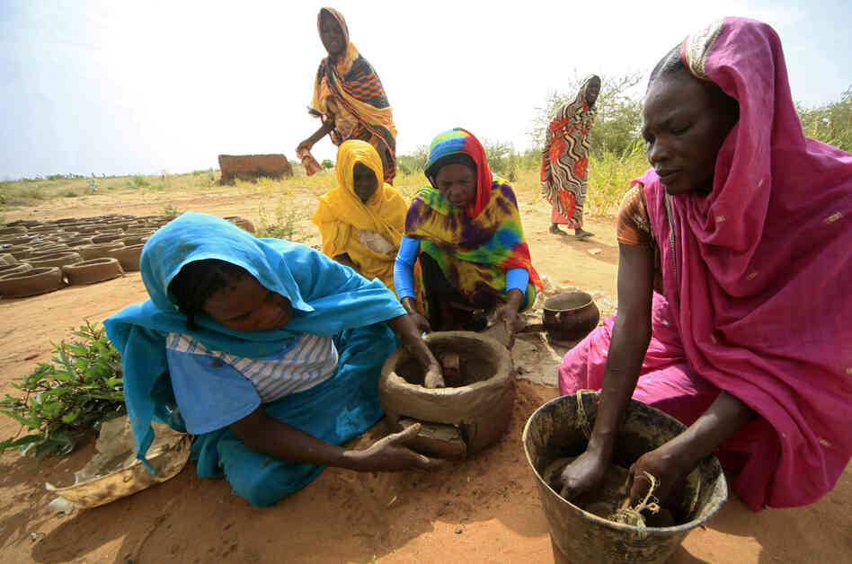 Women make fuel-efficient mud stoves in Darfur, Sudan, in October 2012. The stoves save women trips for firewood, a task that leaves them vulnerable to attack. Women make fuel-efficient mud stoves in Darfur, Sudan, in October 2012. The stoves save women trips for firewood, a task that leaves them vulnerable to attack.