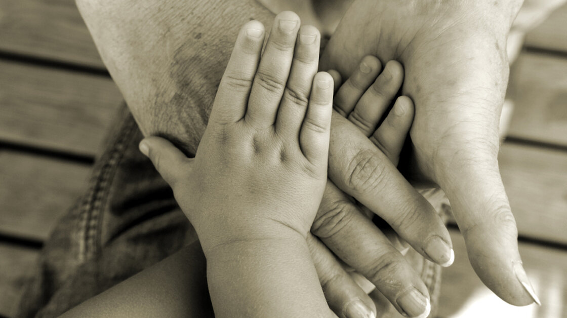 Hands of different ages in a circle.