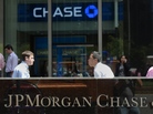 People walk by JPMorgan Chase & Co. headquarters in New York, in August. People walk by JPMorgan Chase & Co. headquarters in New York, in August.